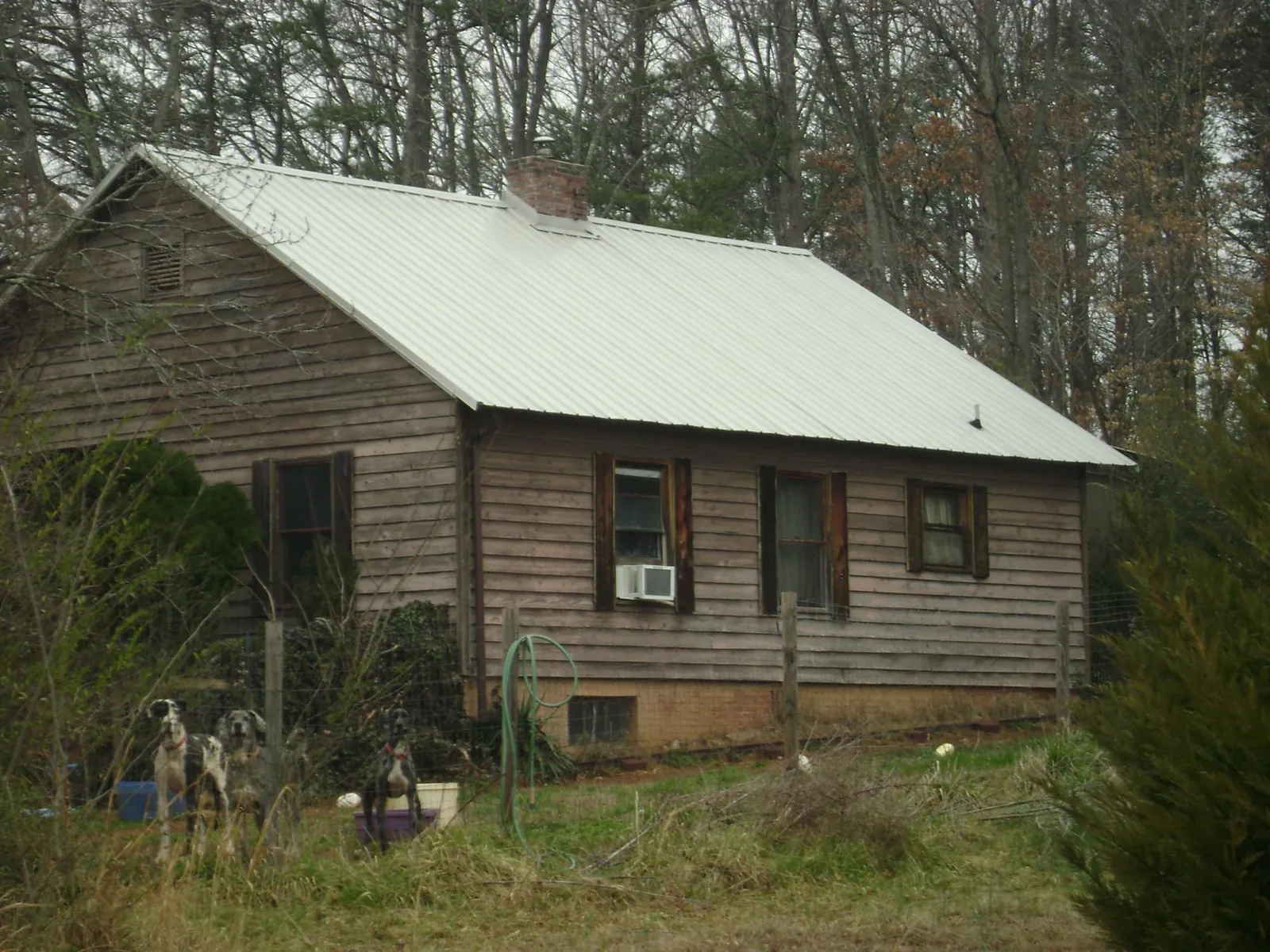 White metal roof on an old wood sided farmhouse, from a Metal Roof Installation job in Enville